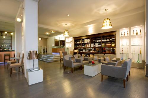 a lobby with chairs and tables and a bar at Hotel Castello di Santa Vittoria in Santa Vittoria dʼAlba