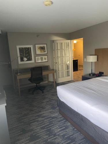 a hotel room with a bed and a desk at Country Inn & Suites by Radisson, Madison, WI in Madison