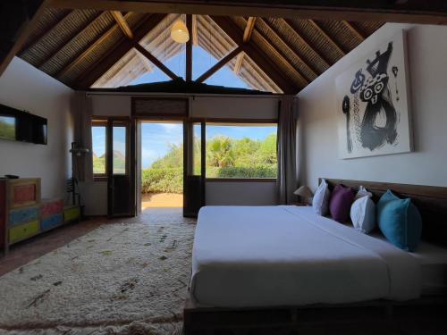 a bedroom with a large bed with a large window at Westpoint Dakhla in Dakhla