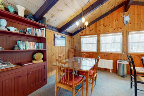 a dining room with a table and chairs at 7 Merrimeeting Chalet in Conway
