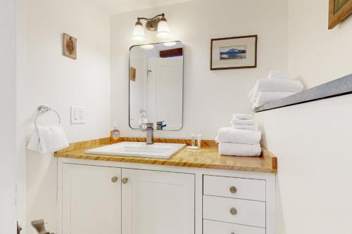 a bathroom with a sink and a mirror at 7 Merrimeeting Chalet in Conway