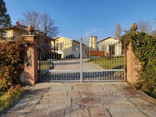 an iron gate to a house with a staircase at Valditerra Vini - B&B La Rombetta in  Tassarolo