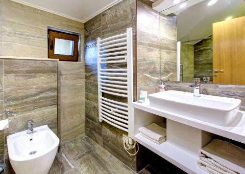 a bathroom with a sink and a mirror at Villa Cardak in Mostar
