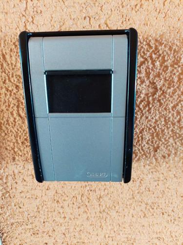 a cell phone sitting on top of a table at Apartman Ares in Osijek