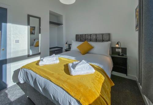 プリマスにあるPiccadilly by Pureservicedのベッドルーム1室(黄色い毛布付きのベッド1台付)