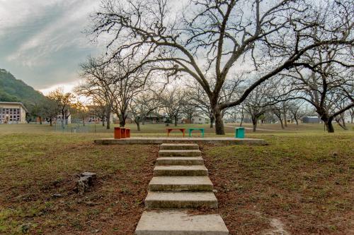 a stepping stone path in a park with a bench at Seven Bluff Cabins in Concan
