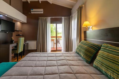 A bed or beds in a room at Harmonie Hotel De Montaña - Adults only