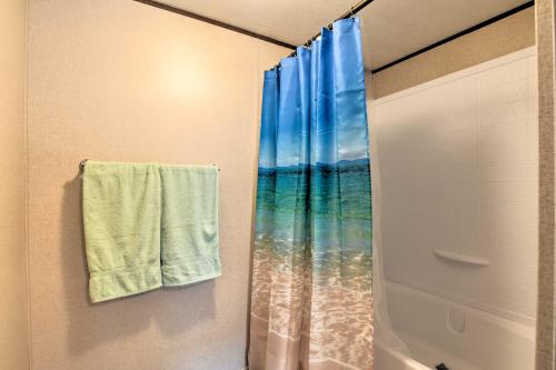a bathroom with a shower curtain and a towel at 3 Mi to Beach Home with Deck in Port OConnor! in Port O'Connor