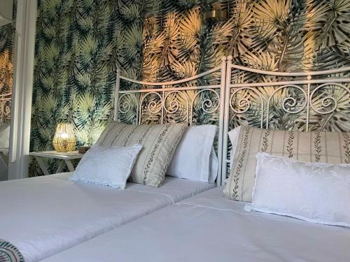 a bed with white pillows in a bedroom at My Sweet Santorini in Benidorm