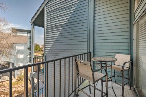 a patio with two chairs and a table on a balcony at Idyllic Montgomery Condo with Pool and Lake View! in Montgomery