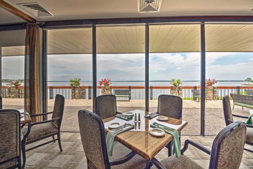 a dining room with a table and chairs and a large window at Idyllic Montgomery Condo with Pool and Lake View! in Montgomery