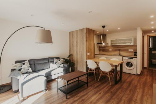 a living room with a couch and a table at Apartaments 7Gorgs in Campdevánol