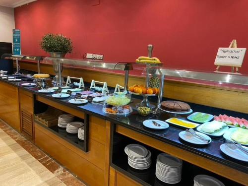 a buffet line with plates of food in a restaurant at Hotel Oasis in Barcelona
