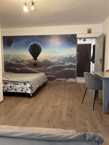 a room with a bedroom with a balloon mural at City Park Studio in Constanţa