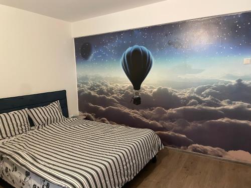 a bedroom with a wall mural of a hot air balloon at City Park Studio in Constanţa