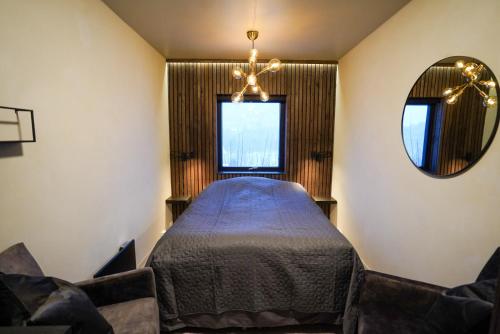 a bedroom with a bed and a mirror at Movegen 84 in Stranda