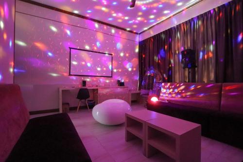 a living room with purple lights on a wall at 2D Fantastic Villa Lot 1857 in Kampong Alor Gajah