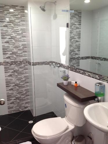 a bathroom with a toilet and a sink at Hotel Burana in Bogotá