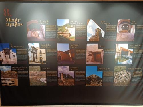 a wall with pictures of historic buildings and monuments at Casa sala pinta in Castellfort