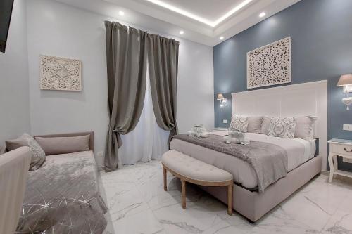a bedroom with a large bed and a couch at Roman Holiday Colosseo in Rome