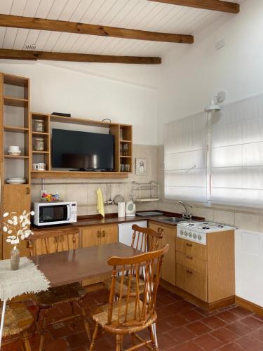a kitchen with a wooden table and a television at Espacio C in Mar del Plata