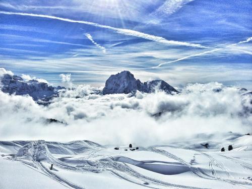 a view of a snow covered mountain in the clouds at Garni Rives in Ortisei