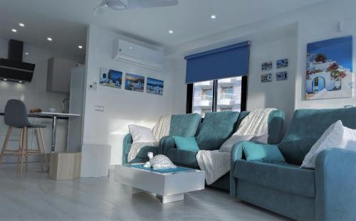 a living room with a couch and a table at My Sweet Santorini in Benidorm