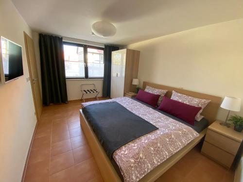 a bedroom with a large bed with purple pillows at Apartment am Pulverturm in Quedlinburg