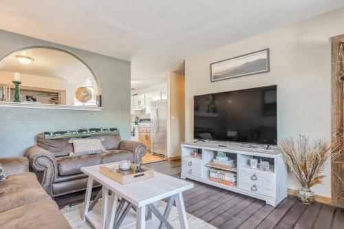 a living room with a couch and a flat screen tv at 5 minutes to downtown and just minutes to military and hospitals in Colorado Springs