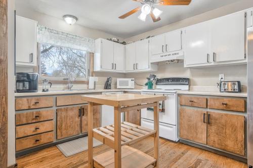 a kitchen with white cabinets and a wooden table at 5 minutes to downtown and just minutes to military and hospitals in Colorado Springs