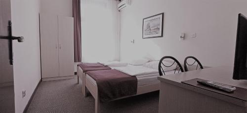 a hospital room with a bed and a desk and a table at Hotel Vojvodina in Novi Sad