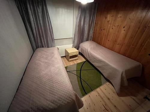 a small room with two beds and a window at Huoneisto Tikkakoski - Apartment in Tikkakoski in Tikkakoski