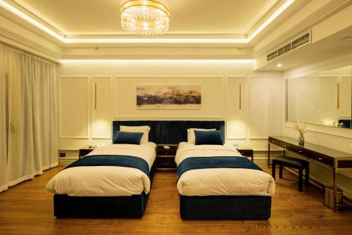 a room with four beds and a desk and a piano at Maran Residence in Cairo