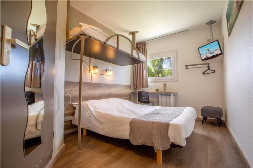 a hotel room with a bed and a bunk bed at Mister Bed Berck in Berck-sur-Mer