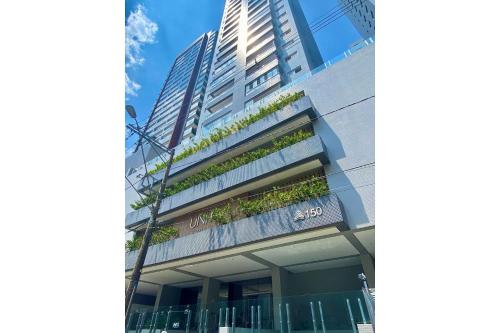 a building with plants on the side of it at Flat Unitá Homestay in Praia Grande