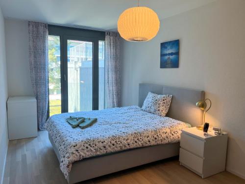 a bedroom with a bed and a large window at Lavish 4.5 rooms furnished apartment @Glattbrugg in Glattbrugg
