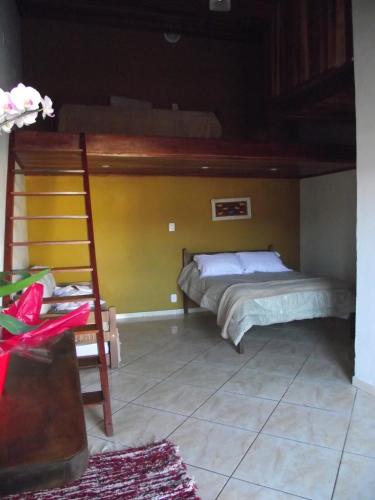 a bedroom with two bunk beds and a ladder at Pousada Mar & Vida e Doçaria in Paraty