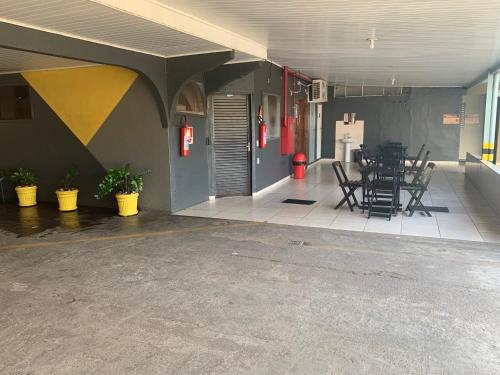 a room with chairs and tables in a building at Porto Seguro Hotel - Porto Velho in Porto Velho