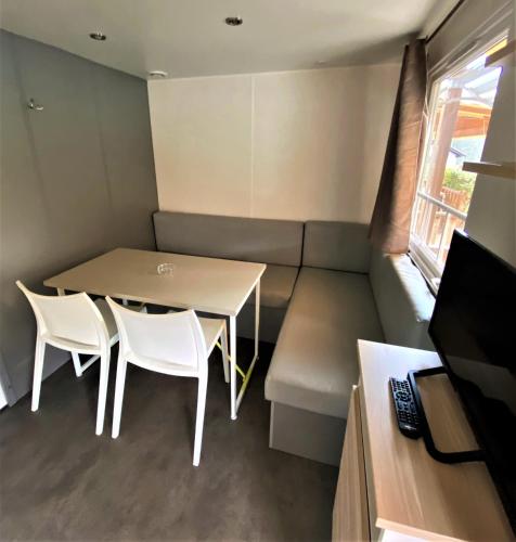 a small room with a table and chairs and a couch at Camping Igara de San Sebastian in Donostia-San Sebastián