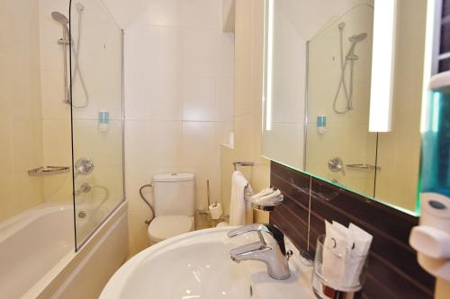 a bathroom with a sink and a toilet and a mirror at 101 Moroni by Cast Renting in Il-Gżira