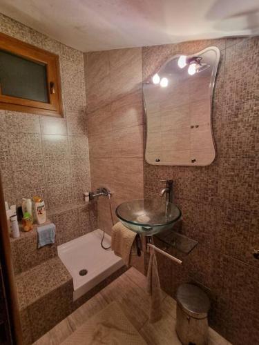 a bathroom with a sink and a mirror at Alatopetra House in Alatopetra