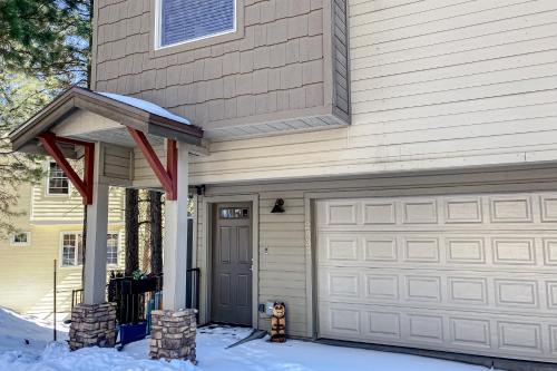 a house with a garage door in the snow at Pikes Peak West in Flagstaff