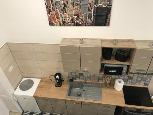 a kitchen with a sink and a counter top at Móra apartman 2 in Kiskunfélegyháza