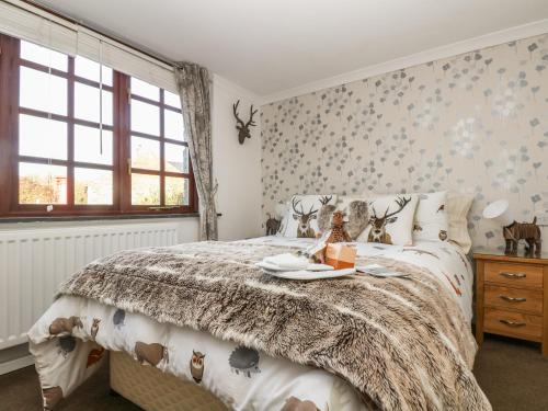 a bedroom with a bed with a tray on it at Phoenix Cottage in Chacewater