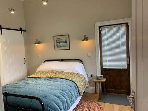 a small bedroom with a bed and a window at One bedroom lodge in the countryside in Congleton