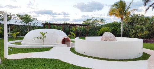 a garden with a pavilion and palm trees at Haven Riviera Cancun - All Inclusive - Adults Only in Cancún