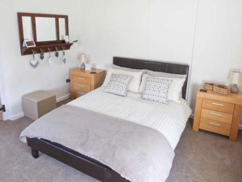 a bedroom with a large bed and a mirror at Wagon House in Horton in Ribblesdale