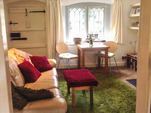 a living room with a couch and a table at 73 Ravensdale Cottages in Millers Dale