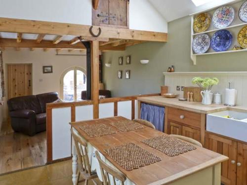 a kitchen with a table and a kitchen with plates on the wall at The Sun House in Ferrensby