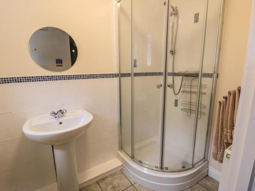 a bathroom with a sink and a shower at No 2 Low Hall Cottages in Scalby